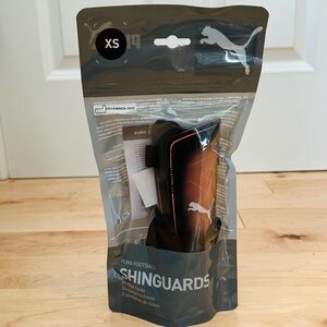 NWT Kids Puma Black and Orange Shinguards (Size XS)